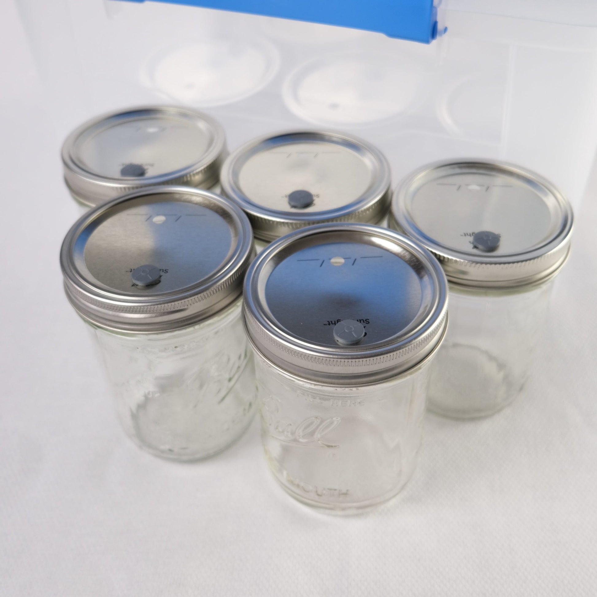 Five glass spawn jars with lids and rings included. The lids have been pre-drilled for the ventilation holes and rubber injection ports; the injection ports are installed in the lids. These are the jars that you will use to cultivate the mycelium (aka grain spawn) for your monotub.
